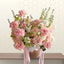 dakar - Bouquet of pink and white flowers in a woven basket with ribbons on a light background