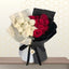 Modern wrapped bouquet featuring white roses on the left and red roses on the right, encased in black and white textured paper with a black ribbon.