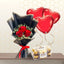 Small bouquet of red roses and baby's breath in black wrapping, next to a box of chocolates and three heart balloons.