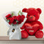 Red rose bouquet in white wrapping sitting next to a giant 90cm red teddy bear.
