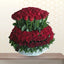 LIFE IS BEAUTIFUL - Bouquet of red roses in a clear container on a light background