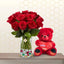 Glass vase filled with red roses standing next to a 40cm red teddy bear.