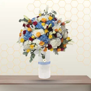 blue and white flowers in tall vase - corporate flowers