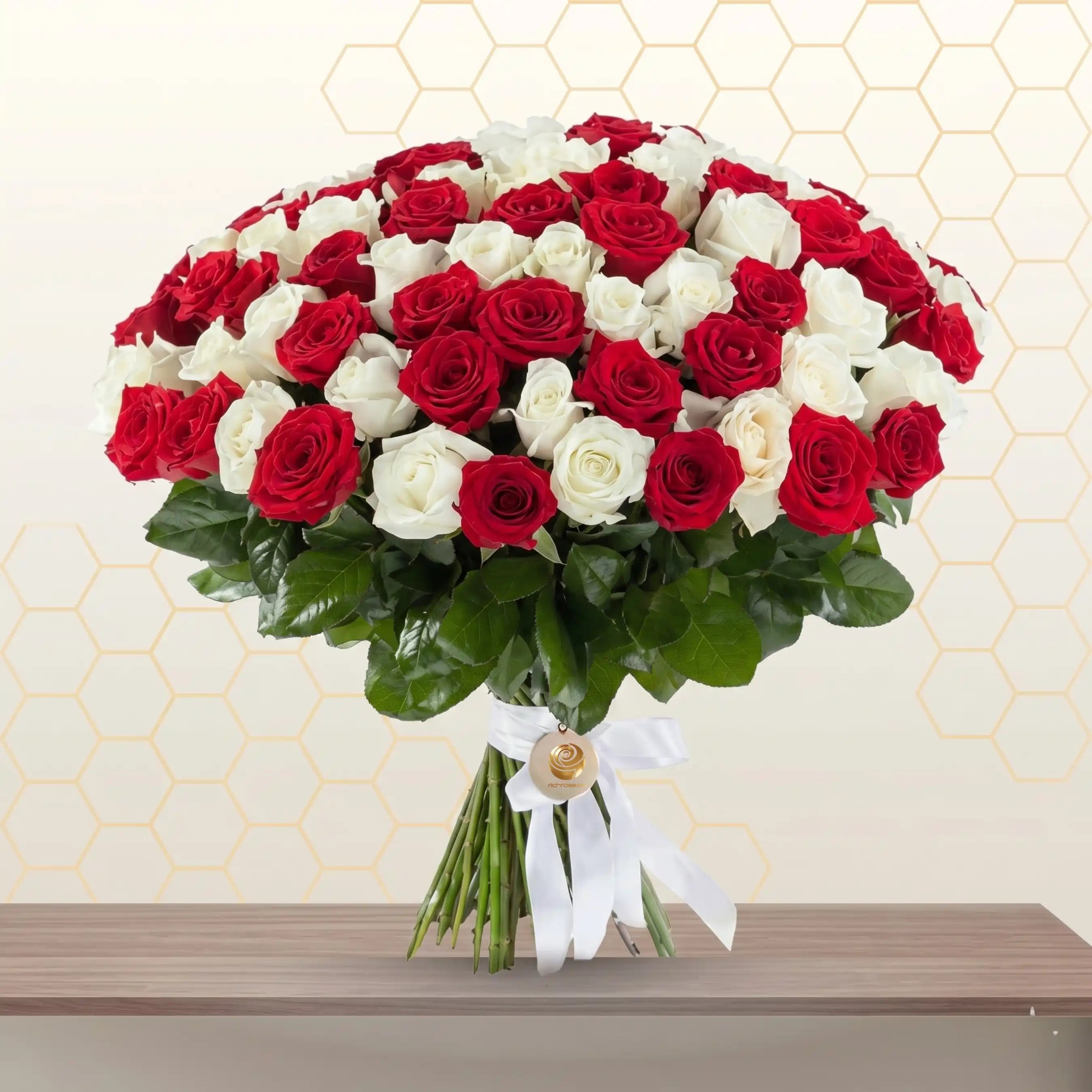 Fresh bunch of pure white and red roses professionally arranged in an elegant floral bouquet. Main image