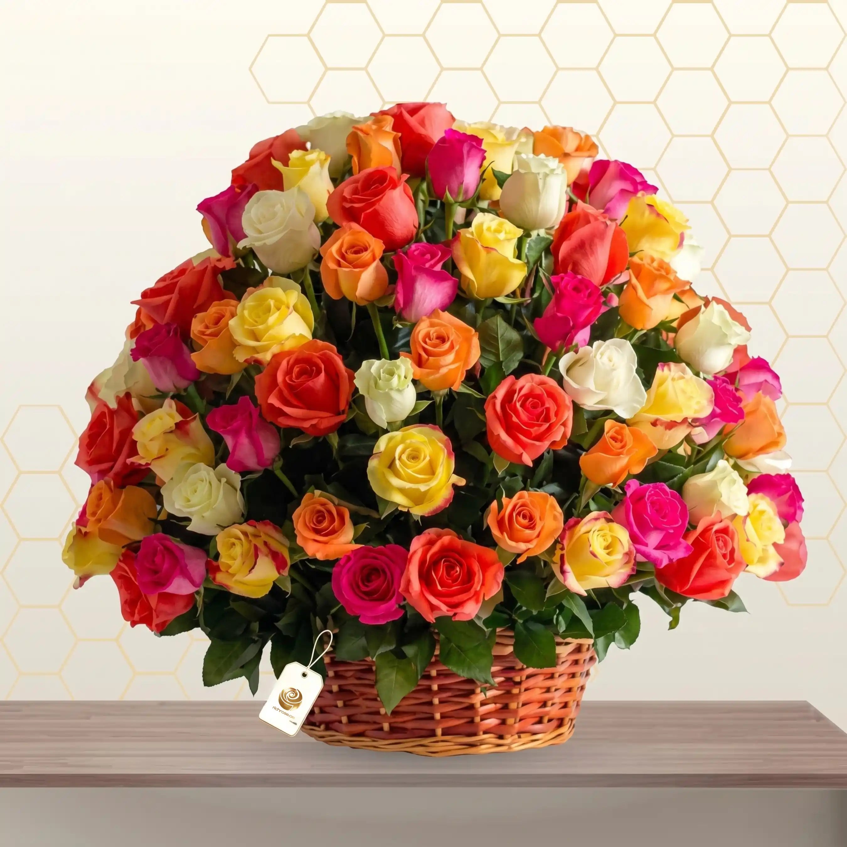 Large wicker basket overflowing with 100 vibrant mixed-color roses in a lush floral arrangement. Main image