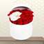 Cardiff premium flower box featuring 20 red roses and a single white orchid in a white cylindrical hatbox on a wooden table.