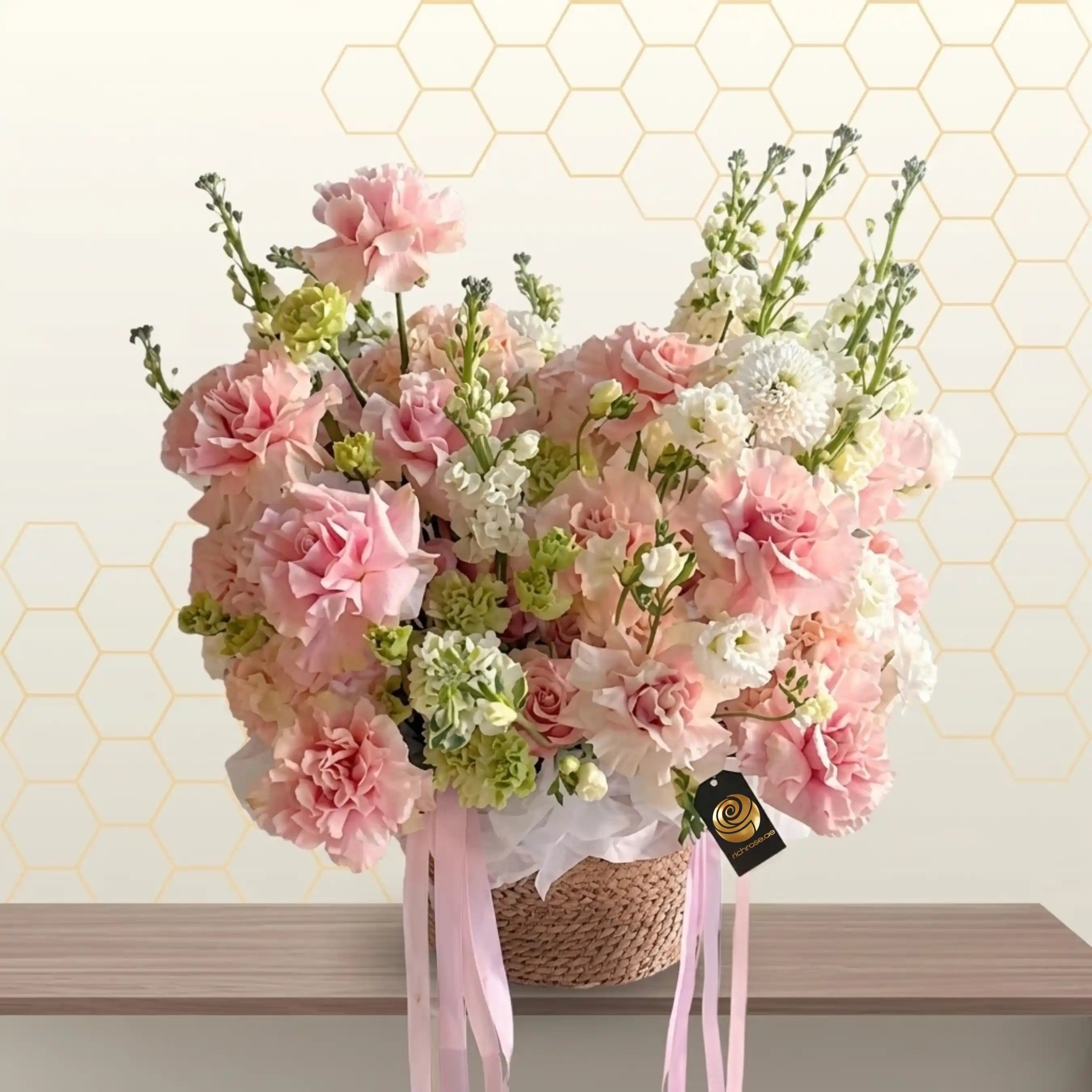 dakar - Bouquet of pink and white flowers in a woven basket with ribbons on a light background