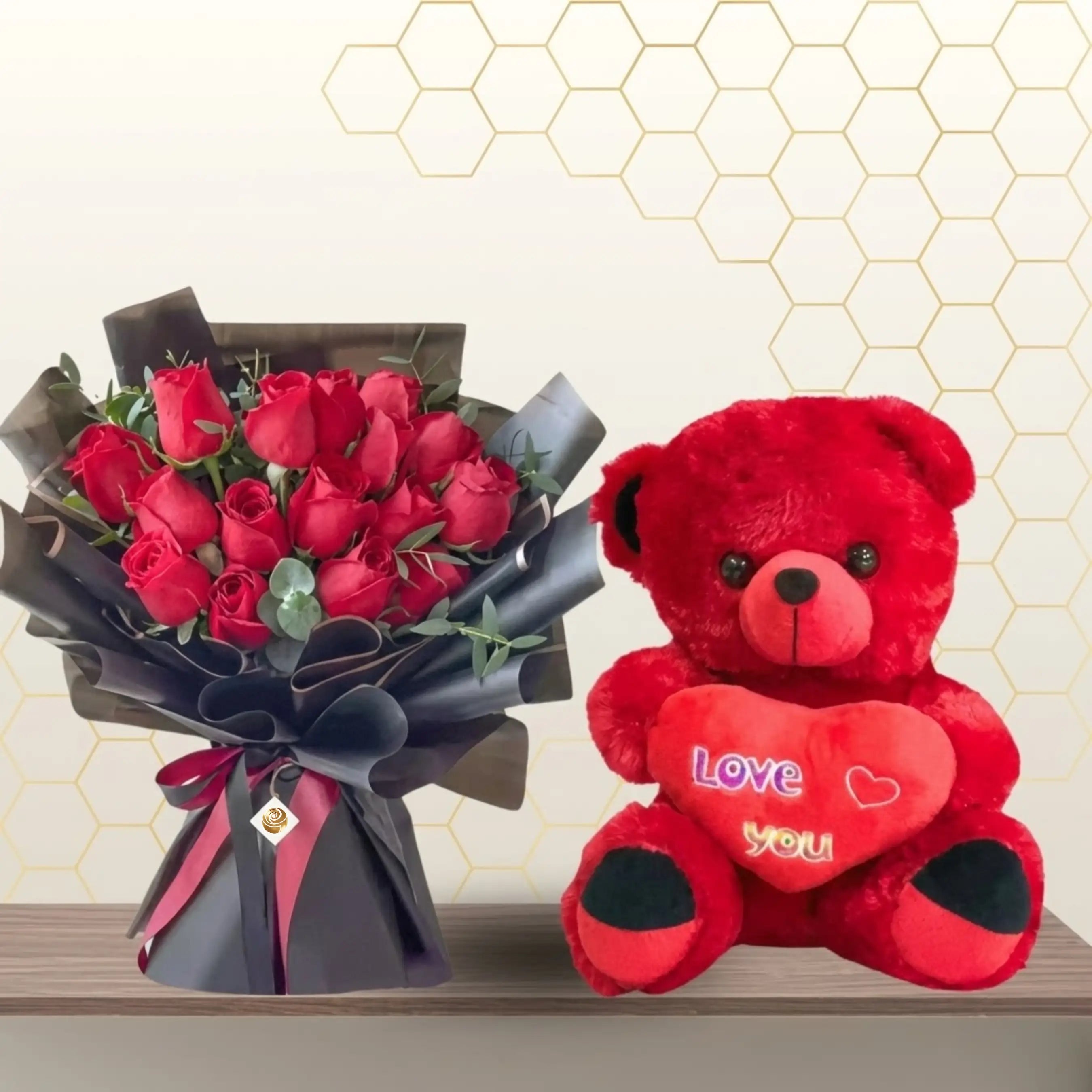 Red rose bouquet in black wrapping standing next to a large 75cm red teddy bear holding a plush heart. Main image