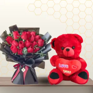 Red rose bouquet in black wrapping standing next to a large 75cm red teddy bear holding a plush heart. Main image