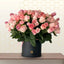 honey bun - Bouquet of pink and white roses in a black box on a wooden surface with a light background
