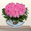 pink roses in white round box