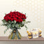 Large hand-tied bouquet of red roses and eucalyptus greenery next to a box of Ferrero Rocher chocolates.