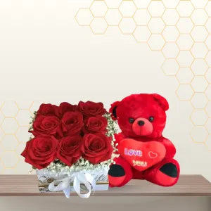 Square marble-patterned flower box with red roses and baby's breath sitting next to a 60cm red teddy bear. Main image