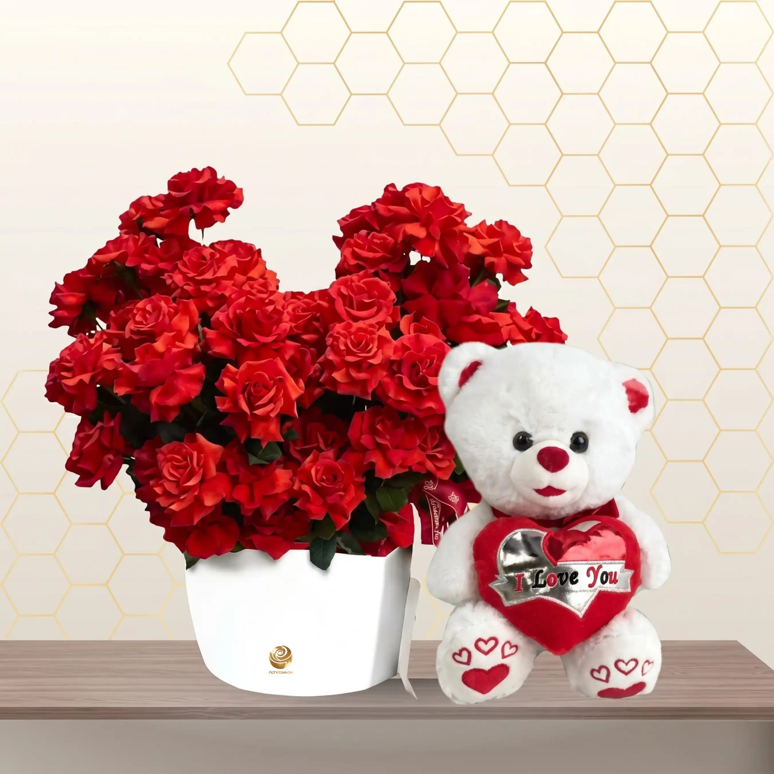 White flower box filled with red spray roses sitting next to a 45cm white teddy bear holding a heart. Main image