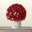 Bouquet of red roses in a white box on a wooden surface with a light background