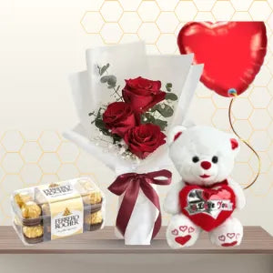 Small bouquet of three red roses in white wrapping, next to a white teddy bear, a box of chocolates, and a red heart balloon. Main image