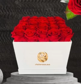 red roses in white square box