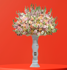 mixed flowers in tall corporate vase