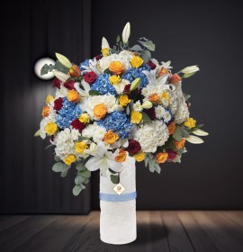 blue and white flowers in tall vase - corporate flowers