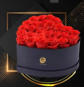 red roses in black heart flower box