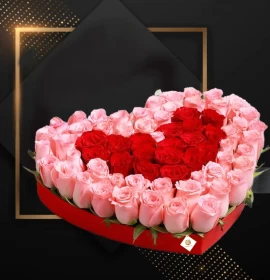 red and pink roses in red heart box