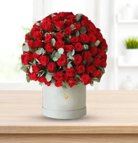 Red roses and eucalyptus arrangement in white hatbox Valentine's gift Dubai
